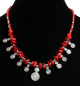 Collier ethnique artisanal pieces imitation corail rouge agence de perles rouges et argentees, decore de breloques tourbillon spirale en metal argente
