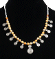Collier ethnique artisanal boules jaunes agencees de perles argentees et autres blanches, agremente de petits pendentifs tourbillon en metal argente