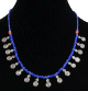 Collier artisanal imitation perles bleues agencees de perles argentees et autres en bois, agremente de petites breloques tourbillon en metal argente