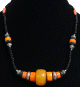 Collier ethnique artisanal perles noires disques et tubes oranges avec agrements argentes ciseles
