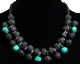 Collier ethnique artisanal imitation pierres noires et vertes agencees de perles et agremente de pieces en metal argente