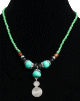 Collier ethnique artisanal perles bleues vertes avec boules imitation turquoise, agremente de pieces argentees et d'un grand pendentif tourbillon en metal argente